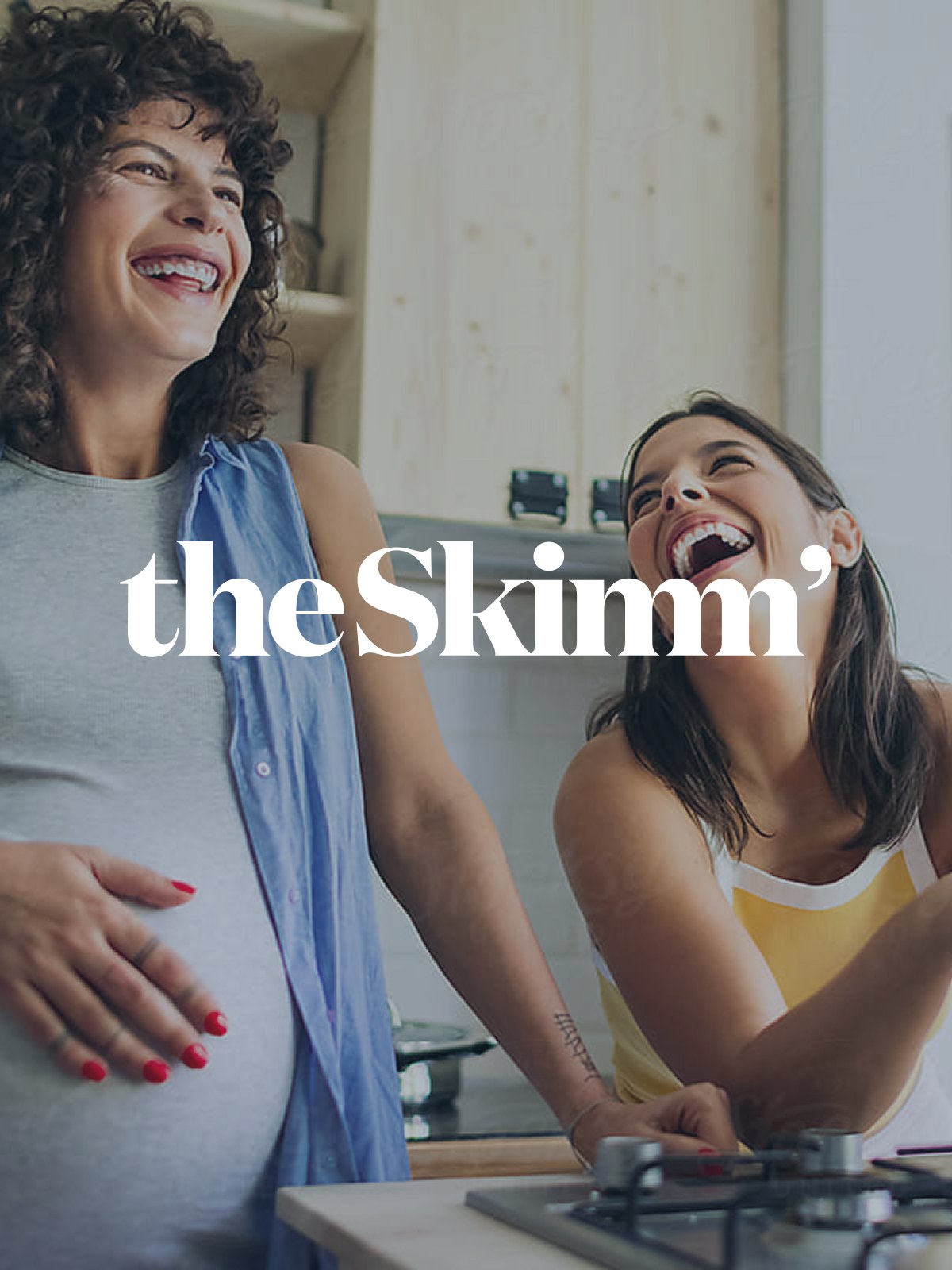 theSkimm wordmark over a photo of two women laughing in a kitchen
