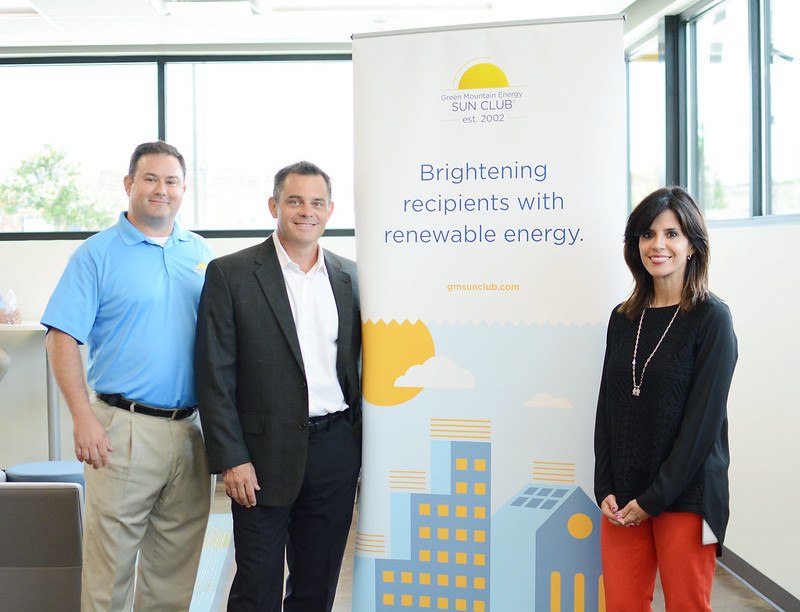 Sun Club team with a pull-up banner